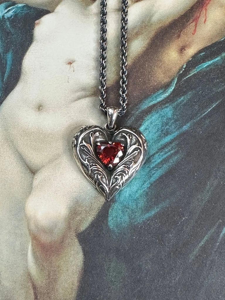 Detailed view of the Artistic Red Heart Necklace with a vibrant red gem.